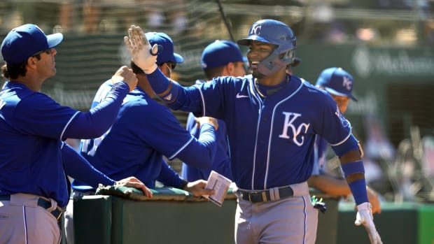 Jun 12, 2021; Oakland, California, USA; Kansas City Royals third baseman Kelvin Gutierrez (19) celebrates with manager Mike Matheny (22) after hitting a two-run home run during the eighth inning against the Oakland Athletics at RingCentral Coliseum. Mandatory Credit: Darren Yamashita-USA TODAY Sports